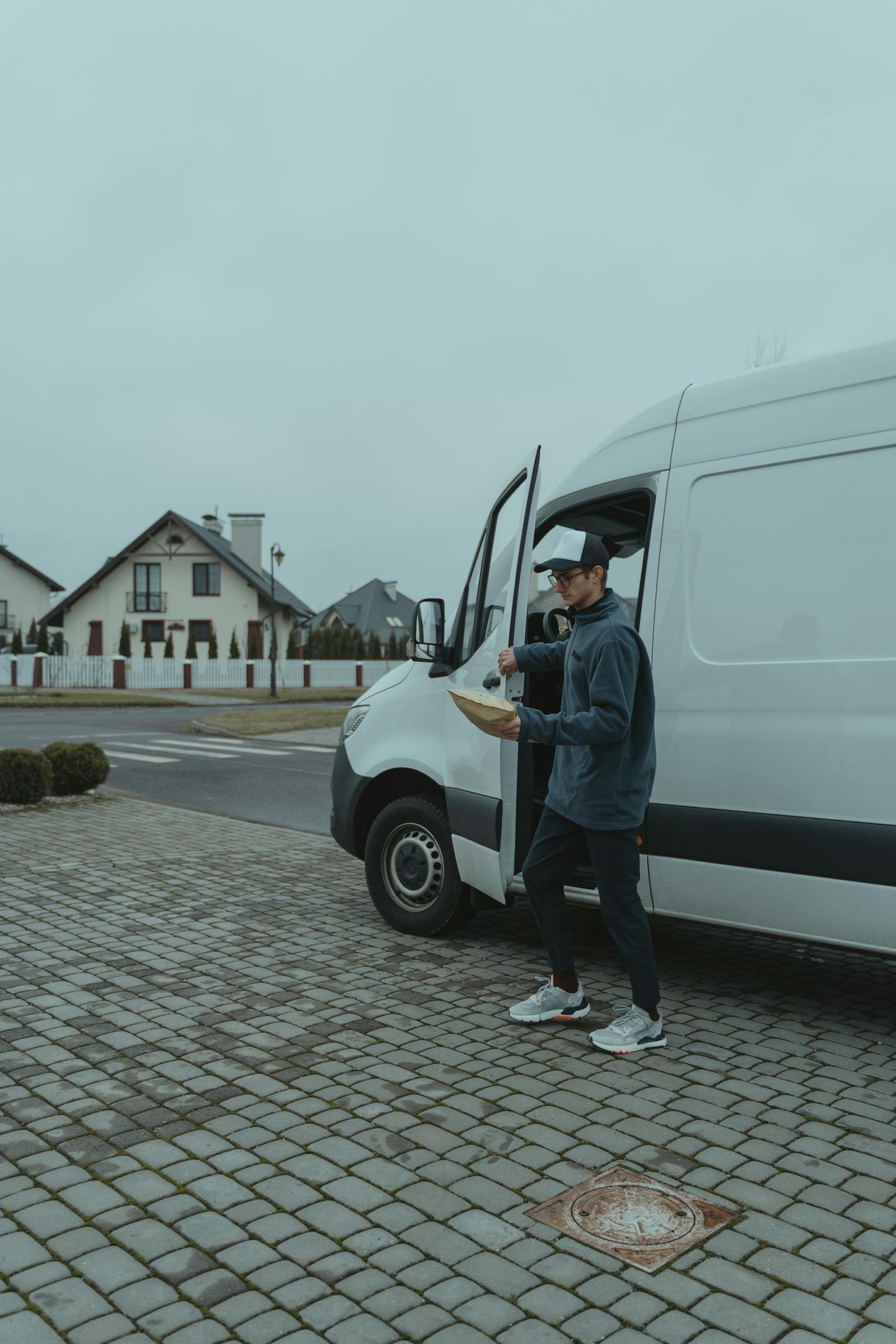 Team member carrying a parcel from a van