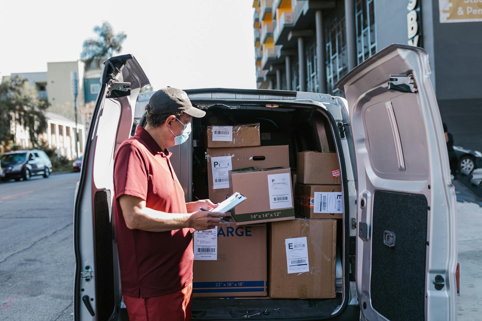 Team member checking parcels inside a van