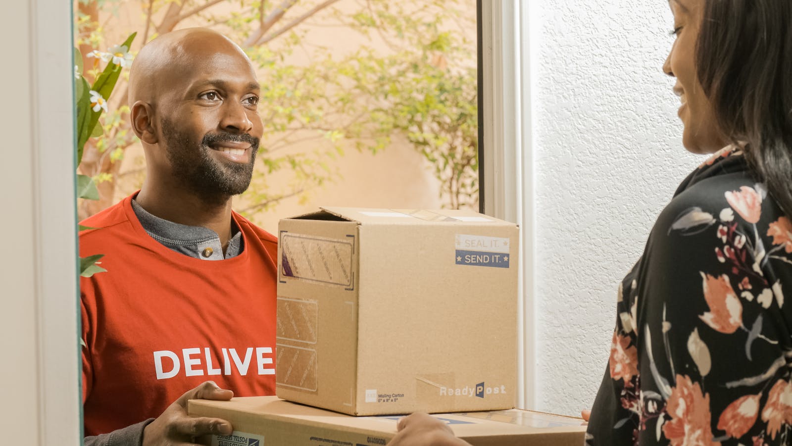 Professional parcel handoff at a customer's door